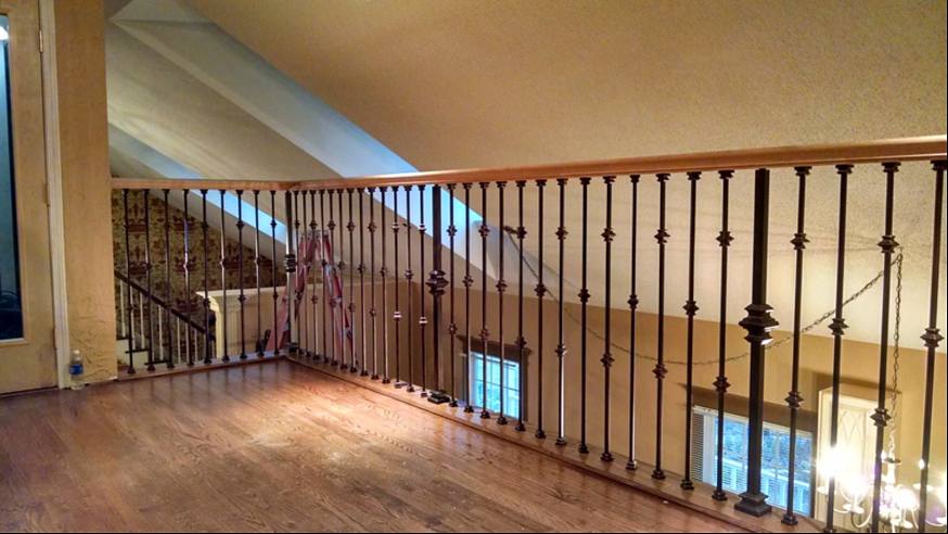 Loft with hardwood floors and a new wrought-iron railing