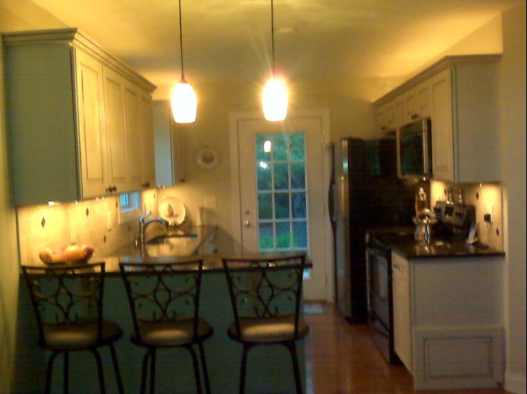 Kitchen with pendant lights and a breakfast bar