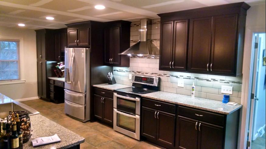 Range wall with a stainless hood and under-cabinet lighting
